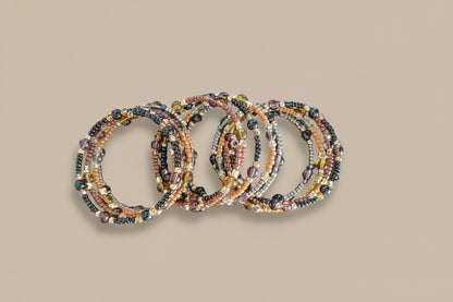 Experience the ultimate versatility and style with our 4 coil memory wire bracelet! Made with 6mm black and tan beads, accented by black, tan, and silver seed beads, and finished with eye-catching gold spacer beads. Elevate any outfit with this unique and effortless accessory.