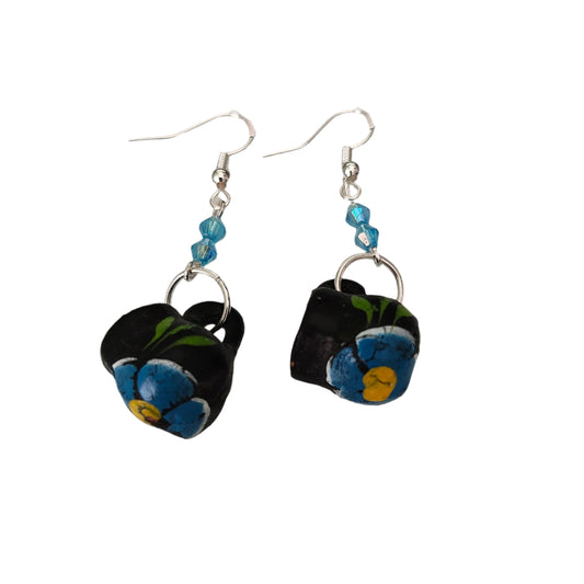 These quirky earrings feature a ceramic Mexican mug with colorful beads hanging from a silver hook. With a length of approximately 2 inches and a weight of only 0.14 oz, they are lightweight and comfortable to wear. Perfect for adding a unique touch to any outfit!