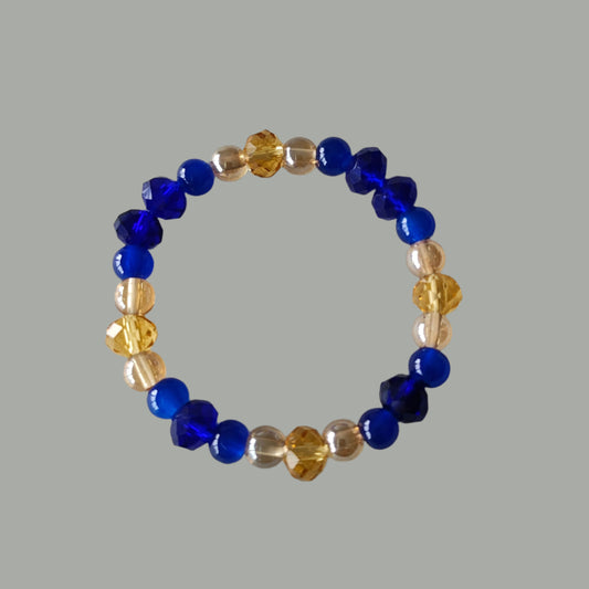 Add a touch of elegance to any outfit with our Bracelet - Elastic 6mm & 8 mm blue & gold glass beads. The elastic design ensures a comfortable fit for all wrist sizes. At a weight of just 0.38 oz, it is lightweight and easy to wear all day long. Elevate your style with this stunning bracelet.

Bracelet - Elastic 6mm & 8 mm blue & gold glass beads