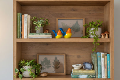 Two colorful bird figurines on a wooden surface