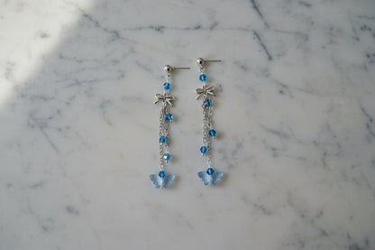 Elevate your everyday style with these enchanting butterfly earrings, featuring delicate silver chains, a charming bow accent, and sparkling crystal beads suspended from classic silver ball post studs. At approximately 3 inches in length, they offer the perfect balance of presence and wearability, making them ideal for both casual outings and special occasions. Weighing just 0.18 oz, these lightweight beauties won't weigh you down, allowing you to wear them comfortably all day long. The intricate design com