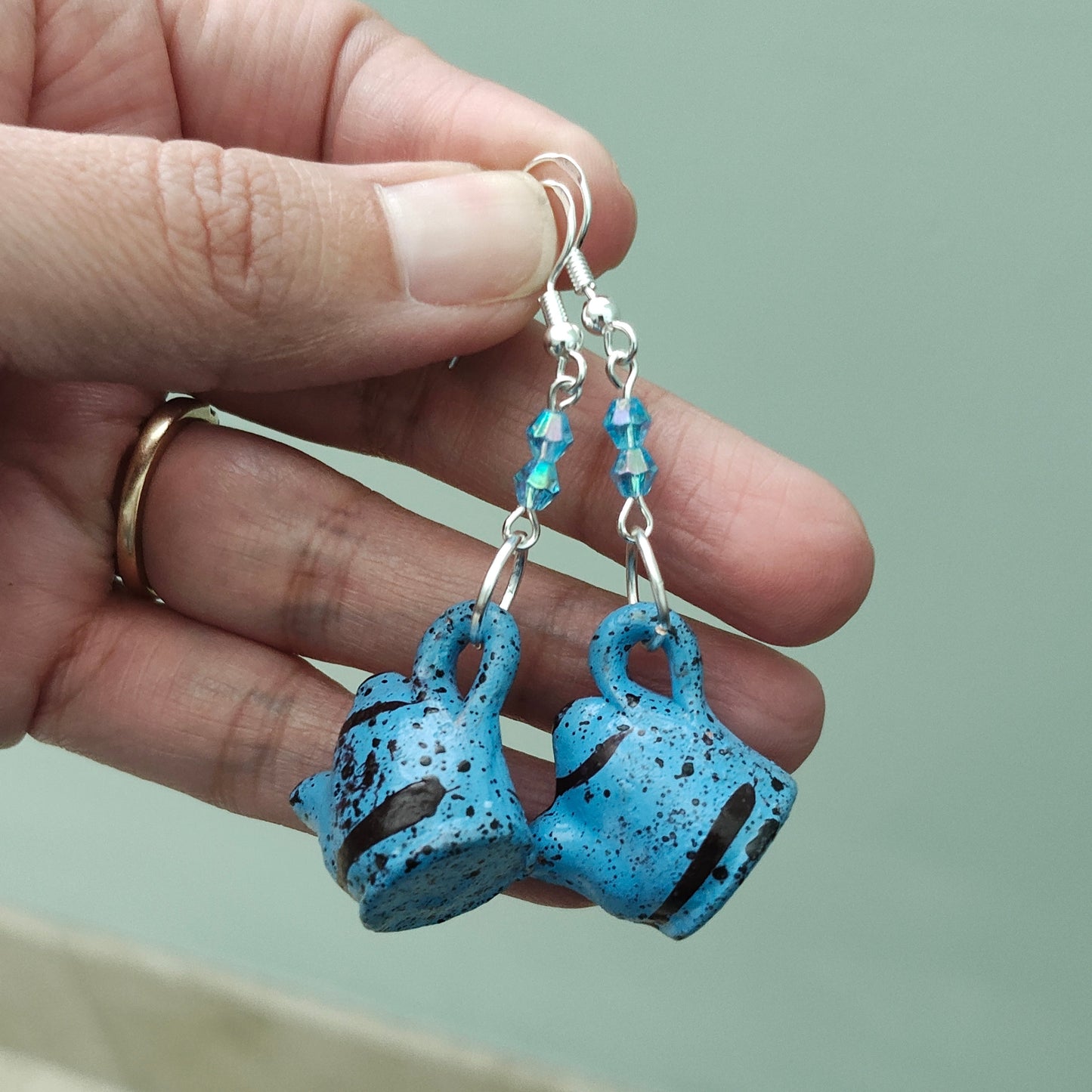 Add a playful and quirky touch to your jewelry collection with our Ceramic Kettle Earrings! These unique earrings feature colorful beads on a silver hook, adding a touch of whimsy to any outfit. Measuring at 2.25 inches in length and weighing just 0.19 ounces, they're the perfect statement piece for any occasion.