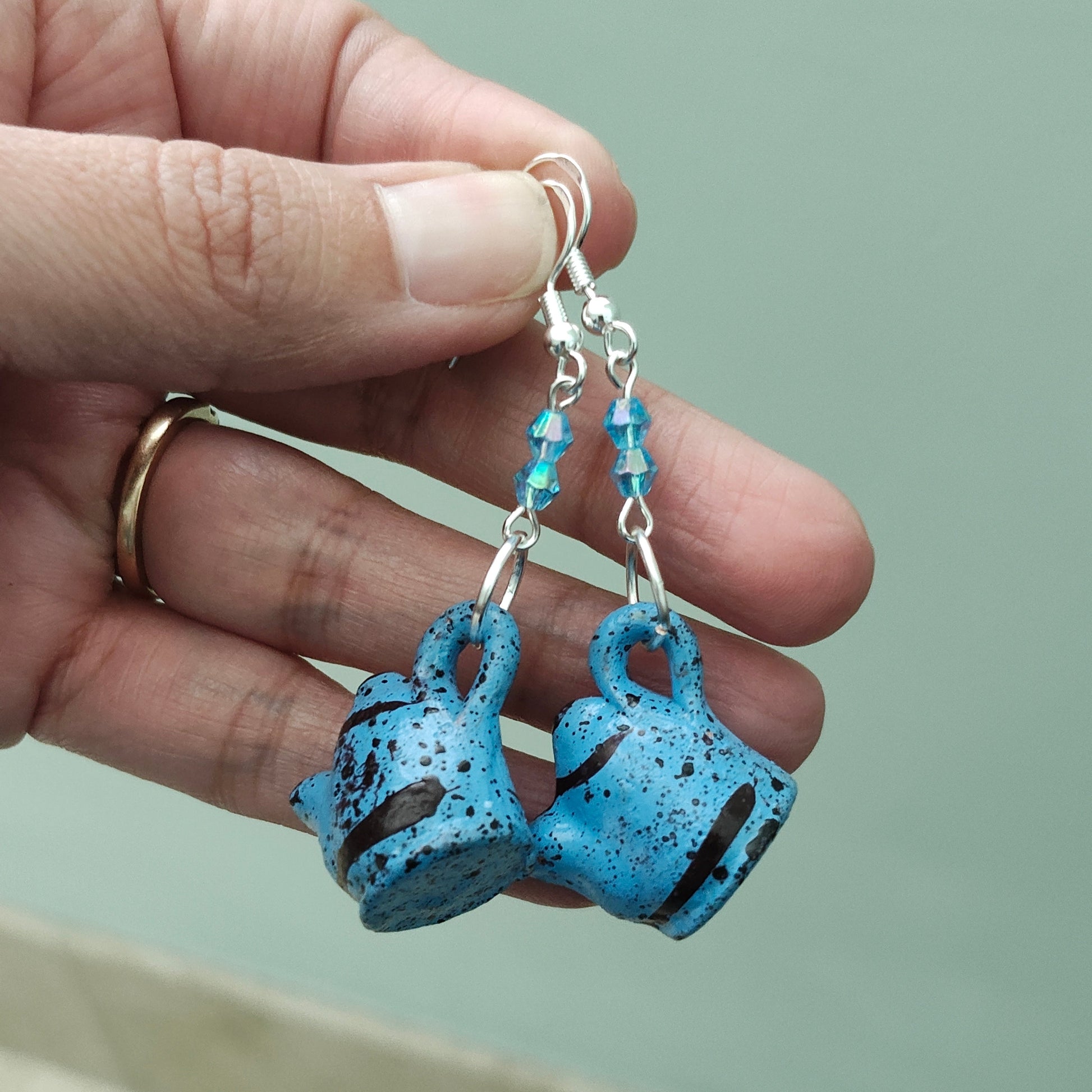 Add a playful and quirky touch to your jewelry collection with our Ceramic Kettle Earrings! These unique earrings feature colorful beads on a silver hook, adding a touch of whimsy to any outfit. Measuring at 2.25 inches in length and weighing just 0.19 ounces, they're the perfect statement piece for any occasion.