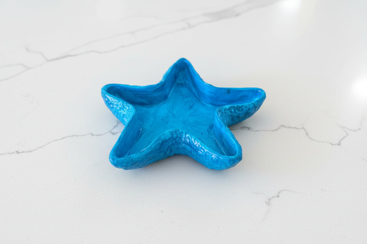 Blue starfish dish on a white marble surface