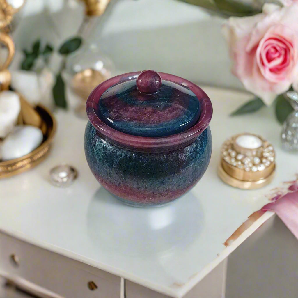 Store your treasures in this quirky Knickknack resin jar with lid. With a convenient size of 2.75 x 2.75 inches and a weight of 7.9 ounces, it's the perfect addition to your home decor. The 3.5-inch height and 2-inch depth make it both functional and stylish. Keep your items safe in style!

Resin Jar with lid

hand crafted with epoxy resin.