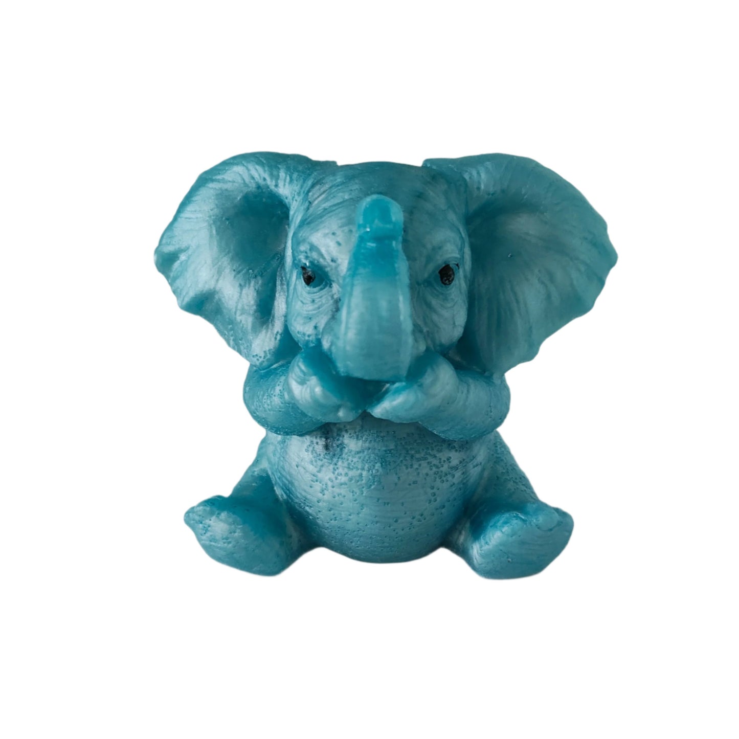 Hand-cast translucent blue resin elephant trinket with its trunk covering its mouth in a speak no evil pose.