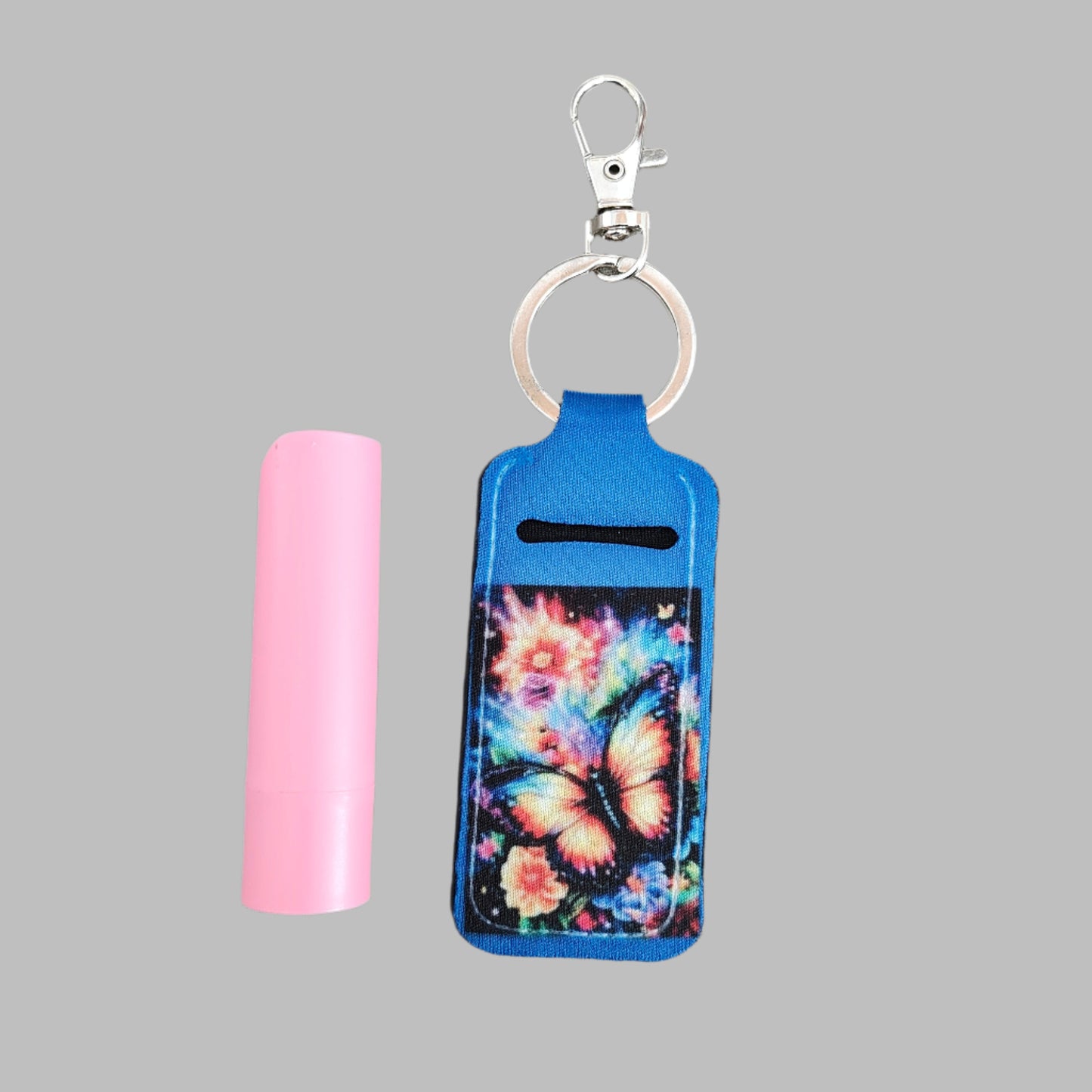 This keychain doubles as a convenient lipstick holder, featuring a colorful, sublimated butterfly design. Keep your favorite lipstick easily accessible while on the go.