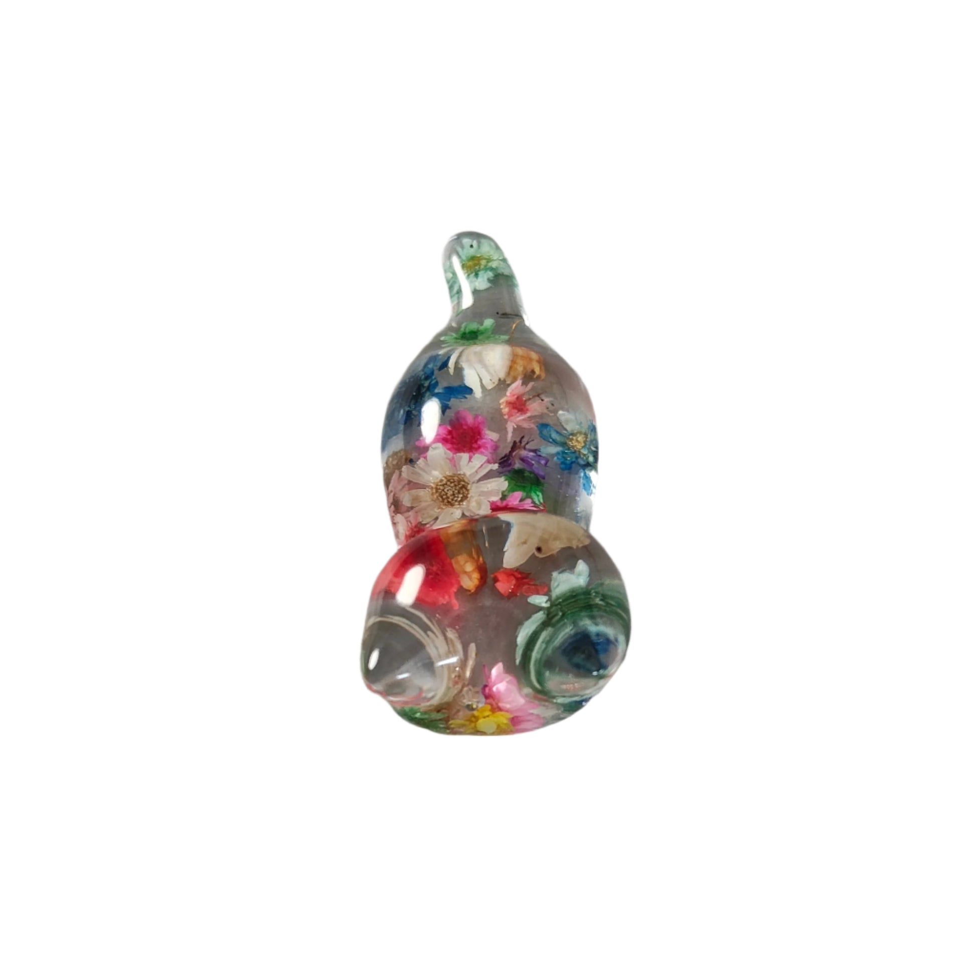 Add some purrfect charm to your home with our playful "Knickknack" resin cat trinket. This small, clear feline is adorned with delicate flowers, making it both stylish and quirky. A unique addition to any knickknack collection.