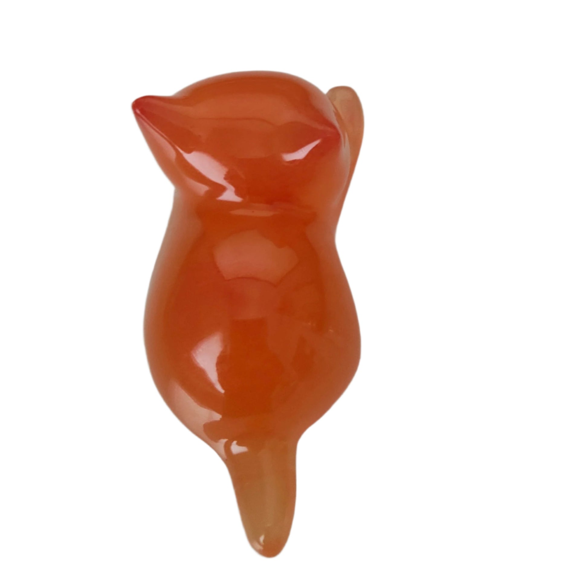 This adorable little orange cat is handcrafted from epoxy resin, giving it a smooth, glass-like finish that's both durable and delightful to hold. Perfect for desk displays, shelf styling, or as a quirky gift for cat lovers, this tiny feline companion measures just 1 x 2.75 inches and weighs less than an ounce—making it easy to tuck into pockets or purses. Each piece showcases the unique character of artisanal resin work, creating a charming trinket that's as fun to look at as it is to collect.
