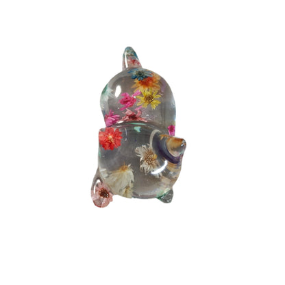 Add some purrfect charm to your home with our playful "Knickknack" resin cat trinket. This small, clear feline is adorned with delicate flowers, making it both stylish and quirky. A unique addition to any knickknack collection.