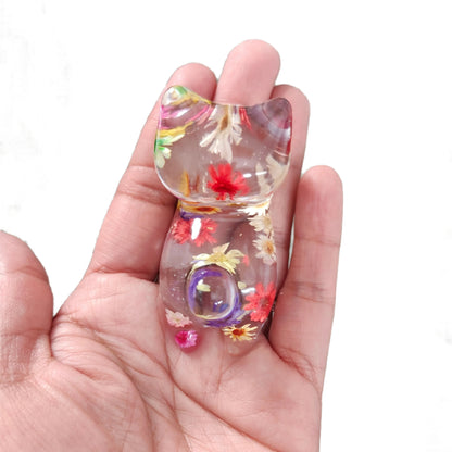 Add some purrfect charm to your home with our playful "Knickknack" resin cat trinket. This small, clear feline is adorned with delicate flowers, making it both stylish and quirky. A unique addition to any knickknack collection.