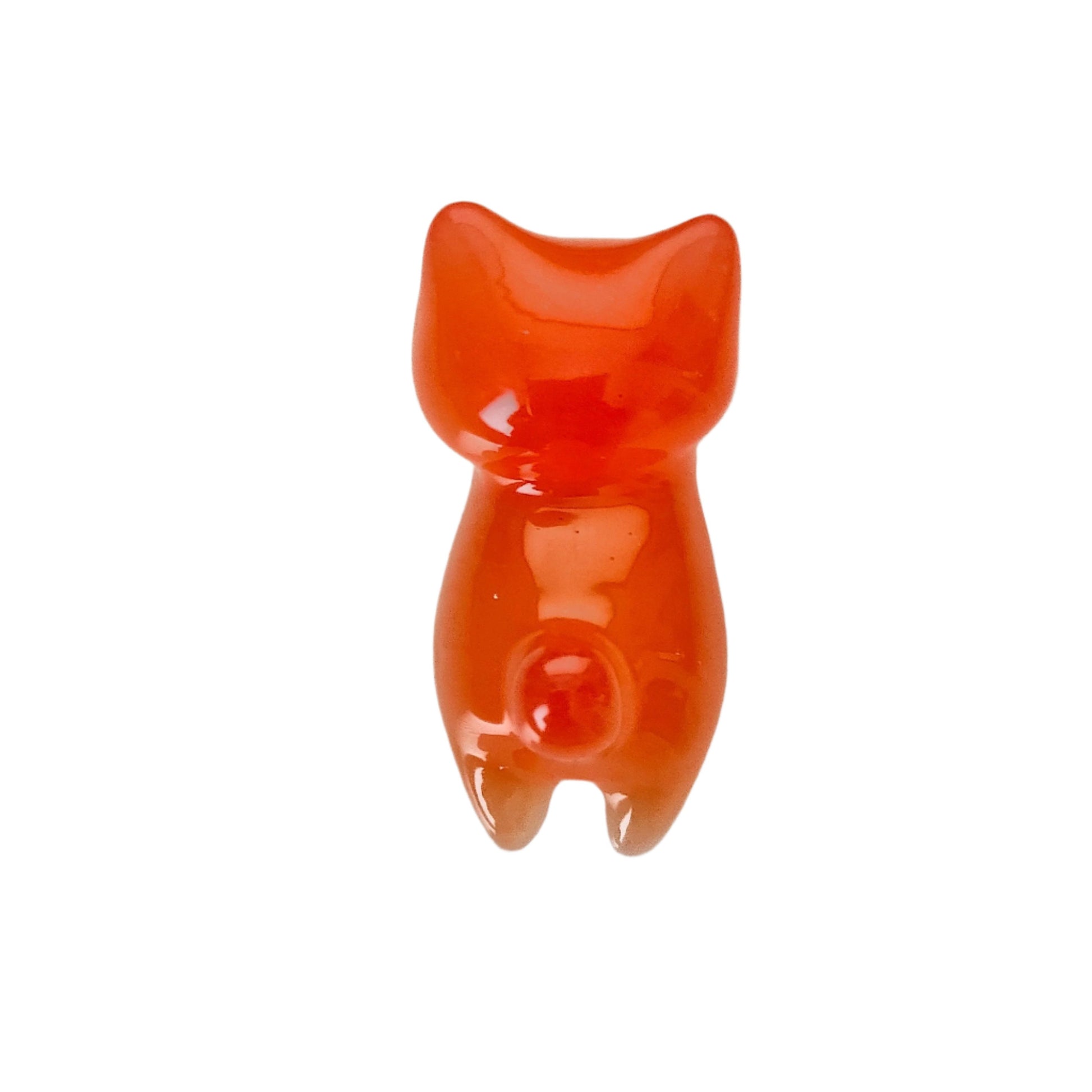 This adorable little orange cat is handcrafted from epoxy resin, giving it a smooth, glass-like finish that's both durable and delightful to hold. Perfect for desk displays, shelf styling, or as a quirky gift for cat lovers, this tiny feline companion measures just 1 x 2.75 inches and weighs less than an ounce—making it easy to tuck into pockets or purses. Each piece showcases the unique character of artisanal resin work, creating a charming trinket that's as fun to look at as it is to collect.