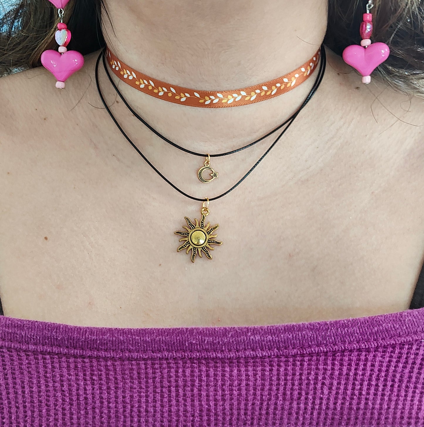 Elevate your style with our Fall Satin Metallic Leaves Choker Necklace! Featuring a delicate ribbon adorned with shimmering leaves, two layers of durable polyester strands, and two elegant gold charms. Make a statement and stand out with this unique and chic accessory. Perfect for any occasion!