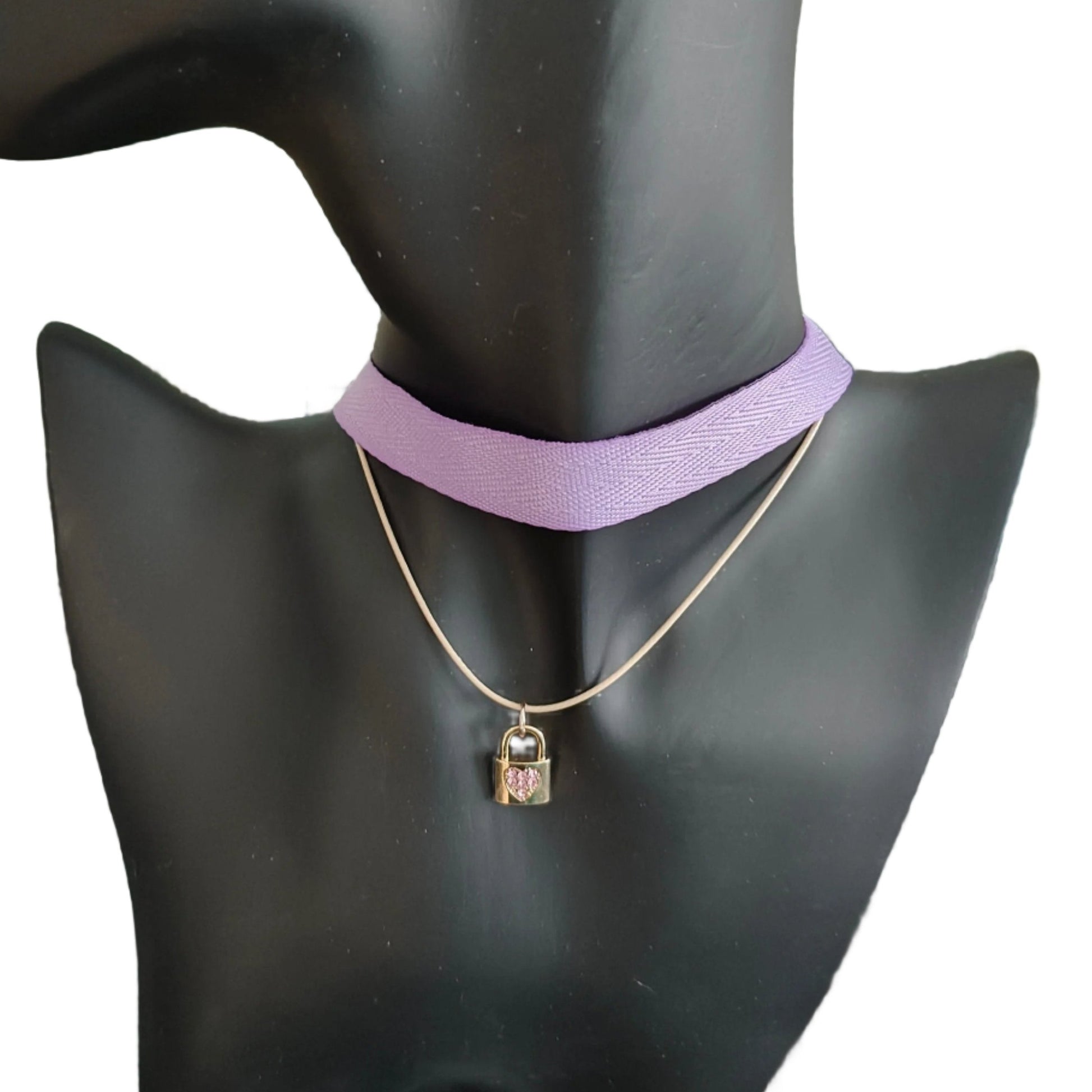 Elevate your style with our exquisite Necklace - Choker purple ribbon! Featuring a luxurious polyester strand and a dazzling gold charm with rhinestone lock, this statement piece is sure to turn heads. Add a touch of elegance and sophistication to any outfit with this stunning necklace.