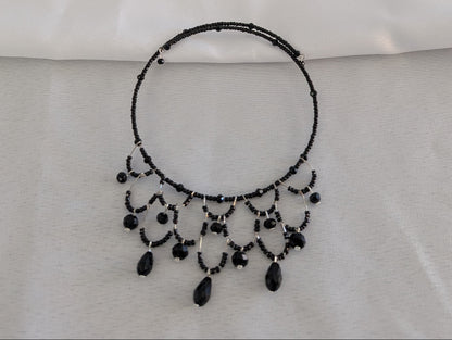 Make a bold statement with this striking black memory wire choker that effortlessly elevates any look. Adorned with shimmering crystal beads and delicate seed beads, this piece delivers sophisticated sparkle in a compact, wearable design. The memory wire construction automatically adjusts to fit your neck perfectly—no clasps or closures needed—while the ultra-lightweight 0.43 oz weight ensures all-day comfort. With a 4-4.5 inch coil diameter, it sits beautifully at the base of your neck for maximum impact. 