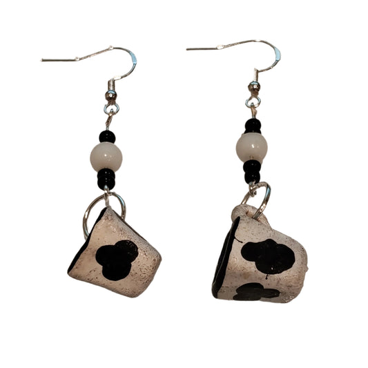 Spice up your style with these quirky cow mug earrings! Made of ceramic, these unique earrings feature a playful cow print design with beads on silver hooks. Lightweight and measuring 2.5 inches long, they're the perfect addition to any fun-loving fashionista's collection. (Moo-vingly cute!)