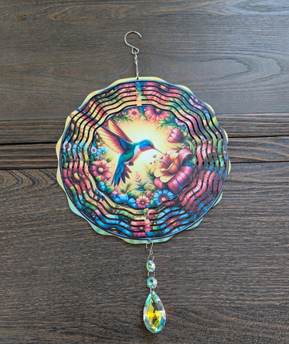 Metal hummingbird wind spinner for garden decor, outdoor hanging kinetic yard art.