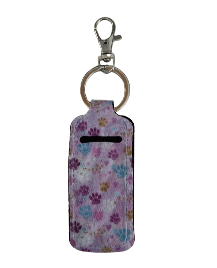 Keep your lipstick close at hand with our sublimated lipstick holder keychain featuring playful paw prints! No more digging through your bag to find your favorite shade - make a statement and stay organized on the go with this stylish and functional accessory. A must-have for any lipstick lover!