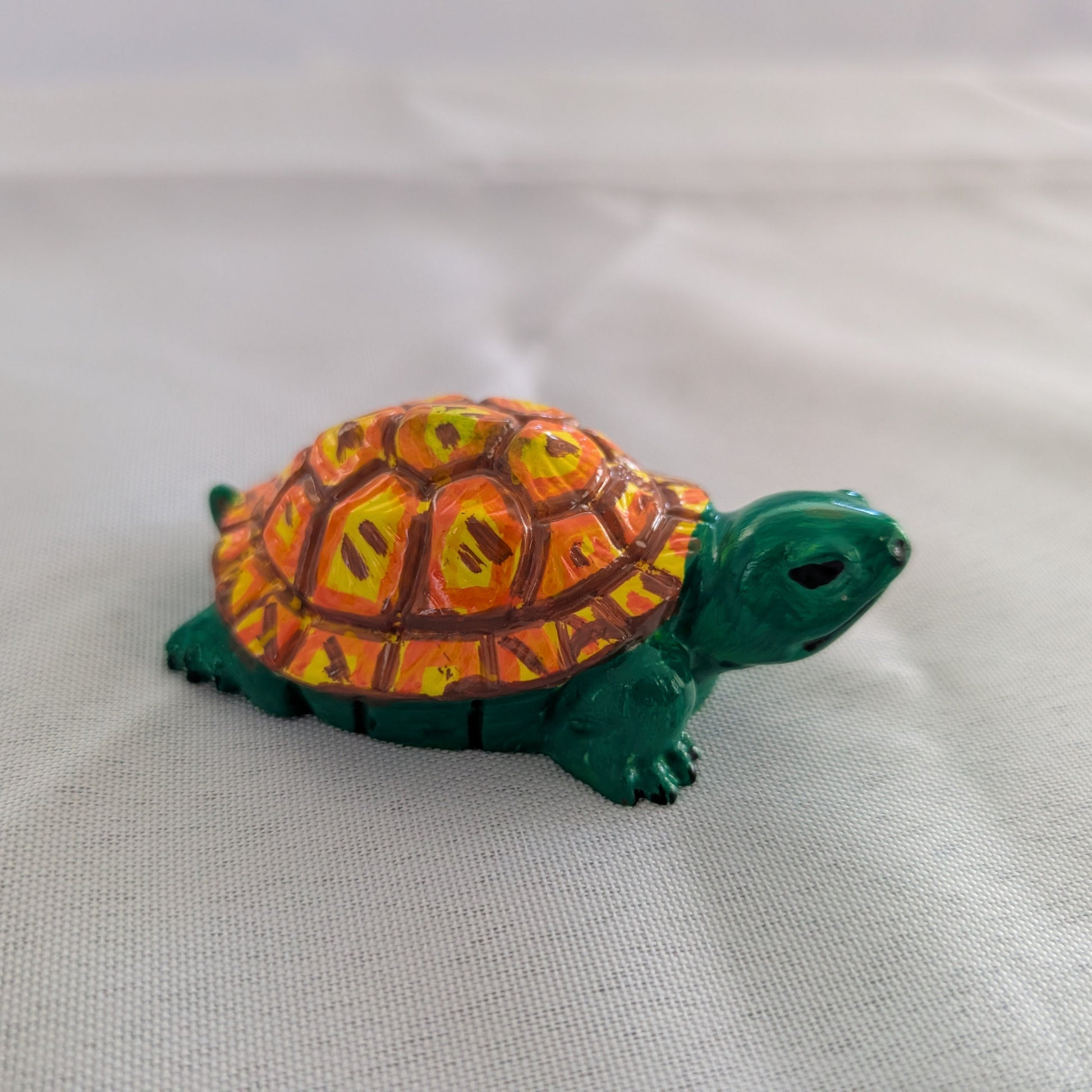 hand crafted with eco resin, and hand painted with acrylic paints.

Eco Resin feels similar to Ceramic or porcelain: smooth, cool to the touch, and non-plastic.