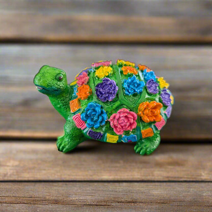 Add a touch of whimsy to your home decor with this adorable Knickknack - Resin Turtle with flowers. Measuring at a perfect 2.25 x 3 inches and weighing just 3 oz, this little guy will fit perfectly on any shelf or desk. His charming design and vibrant flowers will surely put a smile on your face.