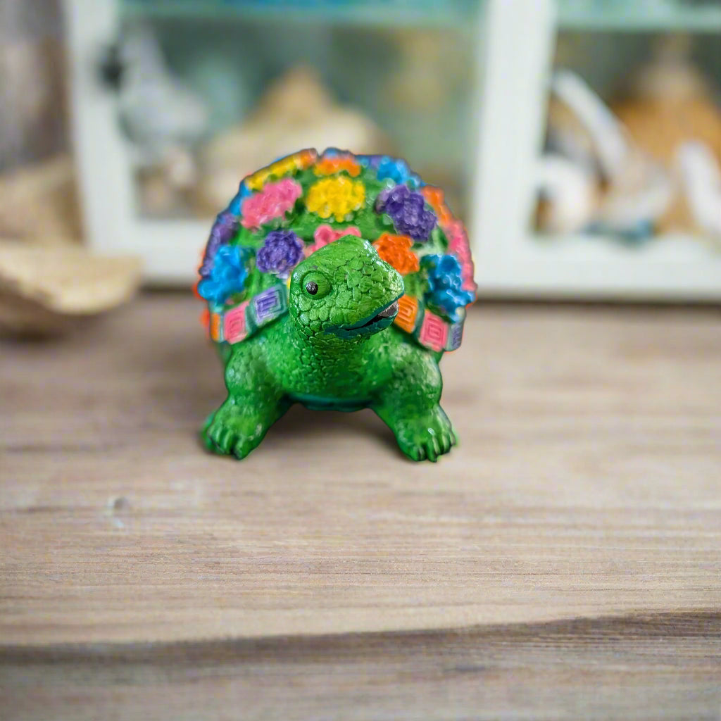 Add a touch of whimsy to your home decor with this adorable Knickknack - Resin Turtle with flowers. Measuring at a perfect 2.25 x 3 inches and weighing just 3 oz, this little guy will fit perfectly on any shelf or desk. His charming design and vibrant flowers will surely put a smile on your face.