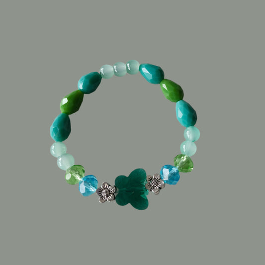 This playful bracelet features a sparkling crystal butterfly bead, elegant blue and green beads, and charming flower metal spacers. The lightweight design weighs just 0.40 oz, making it comfortable for all-day wear. Perfect for adding a touch of whimsy to any outfit.

Bracelet - Elastic Crystal butterfly bead with blue and green beads and flower metal spacer beads

Crystal butterfly bead and 8mm blue and green crystal bead, Glass 8mm blue and green tear drop bead, Glass 6 mm green beads, Metal flower spacer