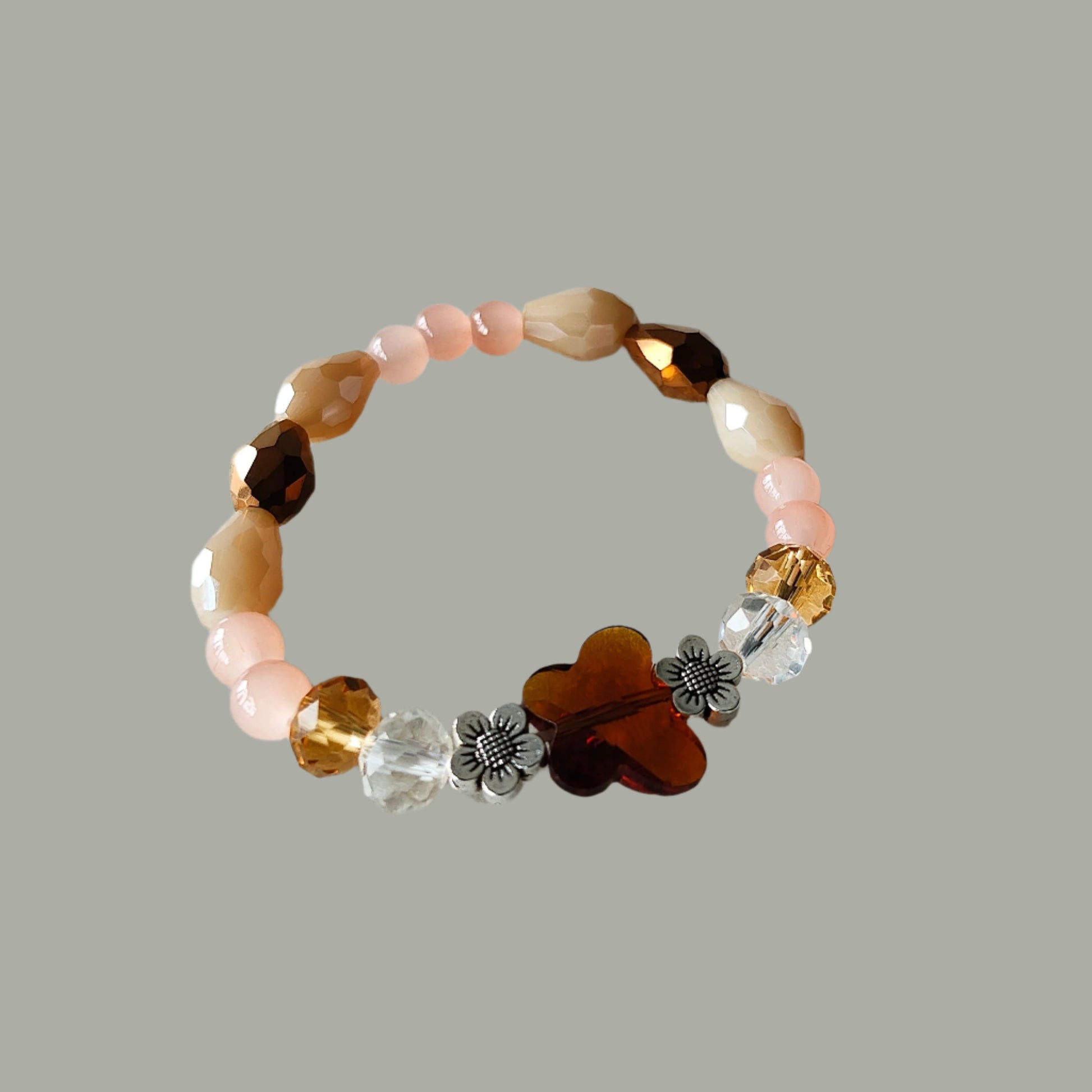 Add a flutter of charm to your outfit with our Butterfly Bracelet. Featuring a crystal butterfly bead and a colorful mix of brown, white, and pink beads, this elastic bracelet effortlessly sparkles. With a weight of just 0.40 oz, it's light as a feather. Fly high in style!

Bracelet - Elastic Crystal butterfly bead with brown, white, & pink beads and flower metal spacer beads

Crystal butterfly bead and 8mm brown and white crystal beads, Glass 8mm white and brown tear drop beads, Glass 6 mm pink beads, Meta