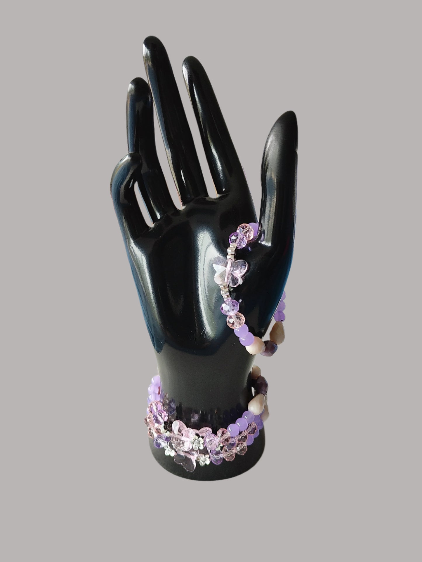 Add a touch of whimsy to your outfit with this elastic crystal butterfly bracelet. Featuring pink and purple crystal and glass beads, along with metal flower spacers, it's sure to catch eyes. Weighing only 0.40 oz, it's lightweight and comfortable to wear.

Bracelet - Elastic Crystal butterfly bead with pink and purple beads and flower metal spacer beads

Crystal butterfly bead and 8mm pink and purple crystal beads, Glass 8mm pink and purple tear drop beads, Glass 6 mm green beads, Metal flower spacer beads