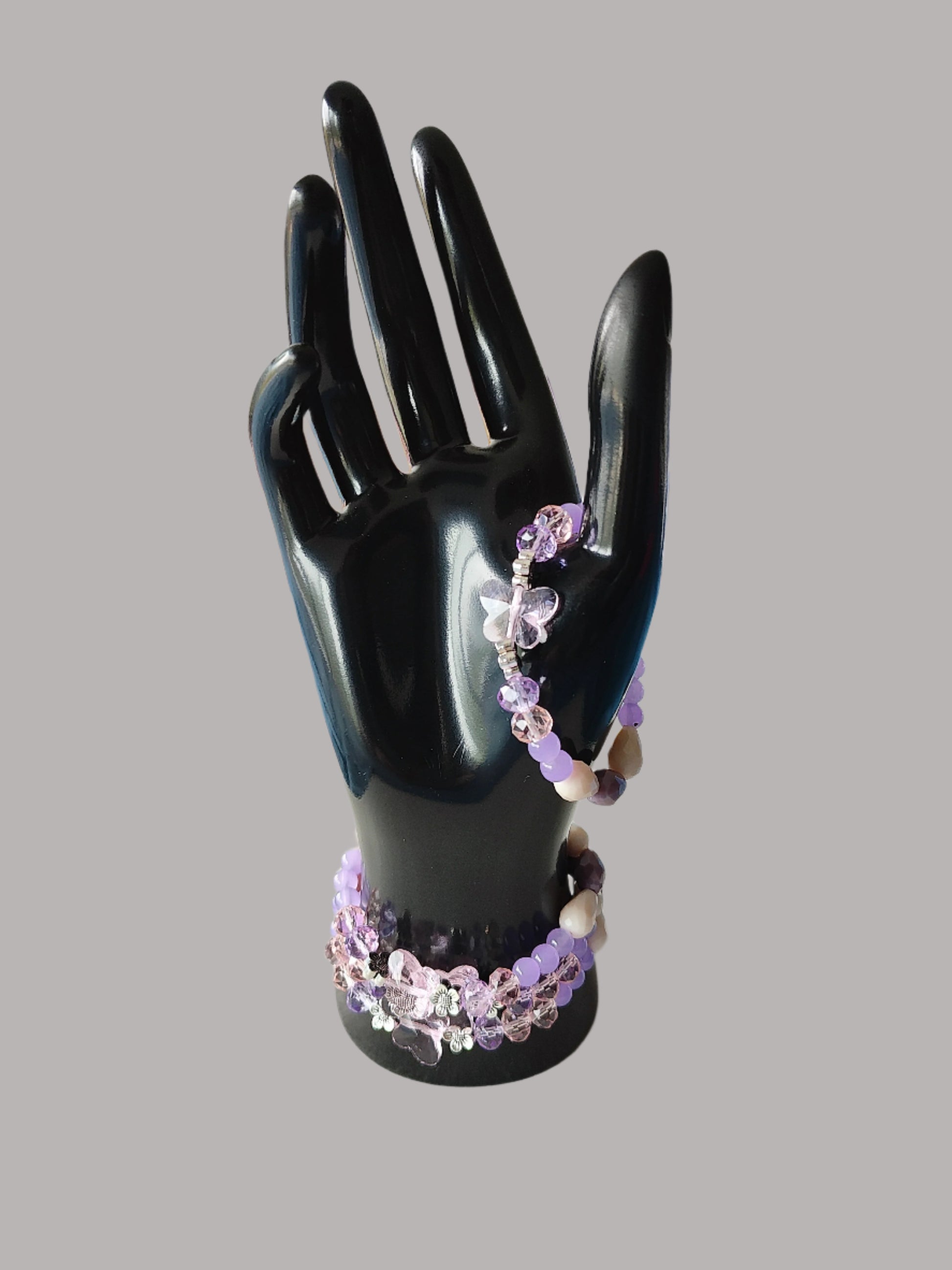 Add a touch of whimsy to your outfit with this elastic crystal butterfly bracelet. Featuring pink and purple crystal and glass beads, along with metal flower spacers, it's sure to catch eyes. Weighing only 0.40 oz, it's lightweight and comfortable to wear.

Bracelet - Elastic Crystal butterfly bead with pink and purple beads and flower metal spacer beads

Crystal butterfly bead and 8mm pink and purple crystal beads, Glass 8mm pink and purple tear drop beads, Glass 6 mm green beads, Metal flower spacer beads