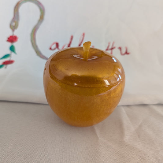 hand crafted with epoxy resin..

Epoxy resin is typically smooth, rigid, and non-porous, similar to a hard plastic or glass.

Knickknack - Resin apple trinket with lid