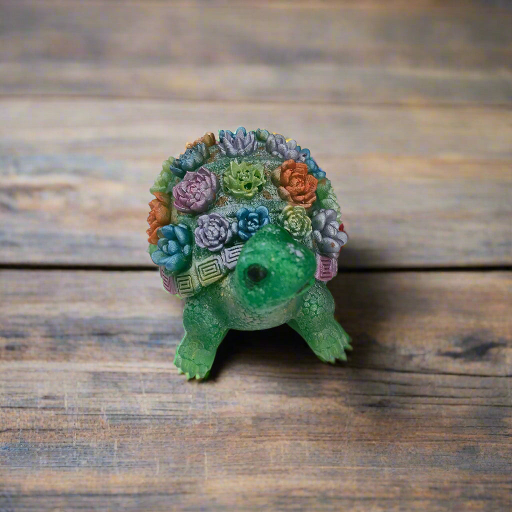 Add a touch of whimsy to your home decor with this adorable Knickknack - Resin Turtle with flowers. Measuring at a perfect 2.25 x 3 inches and weighing just 3 oz, this little guy will fit perfectly on any shelf or desk. His charming design and vibrant flowers will surely put a smile on your face.