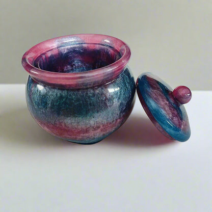 Store your treasures in this quirky Knickknack resin jar with lid. With a convenient size of 2.75 x 2.75 inches and a weight of 7.9 ounces, it's the perfect addition to your home decor. The 3.5-inch height and 2-inch depth make it both functional and stylish. Keep your items safe in style!

Resin Jar with lid

hand crafted with epoxy resin.