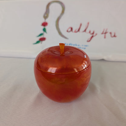 hand crafted with epoxy resin..

Epoxy resin is typically smooth, rigid, and non-porous, similar to a hard plastic or glass.

Knickknack - Resin apple trinket with lid