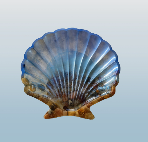 A resin seashell-shaped trinket dish with blue and brown colors.