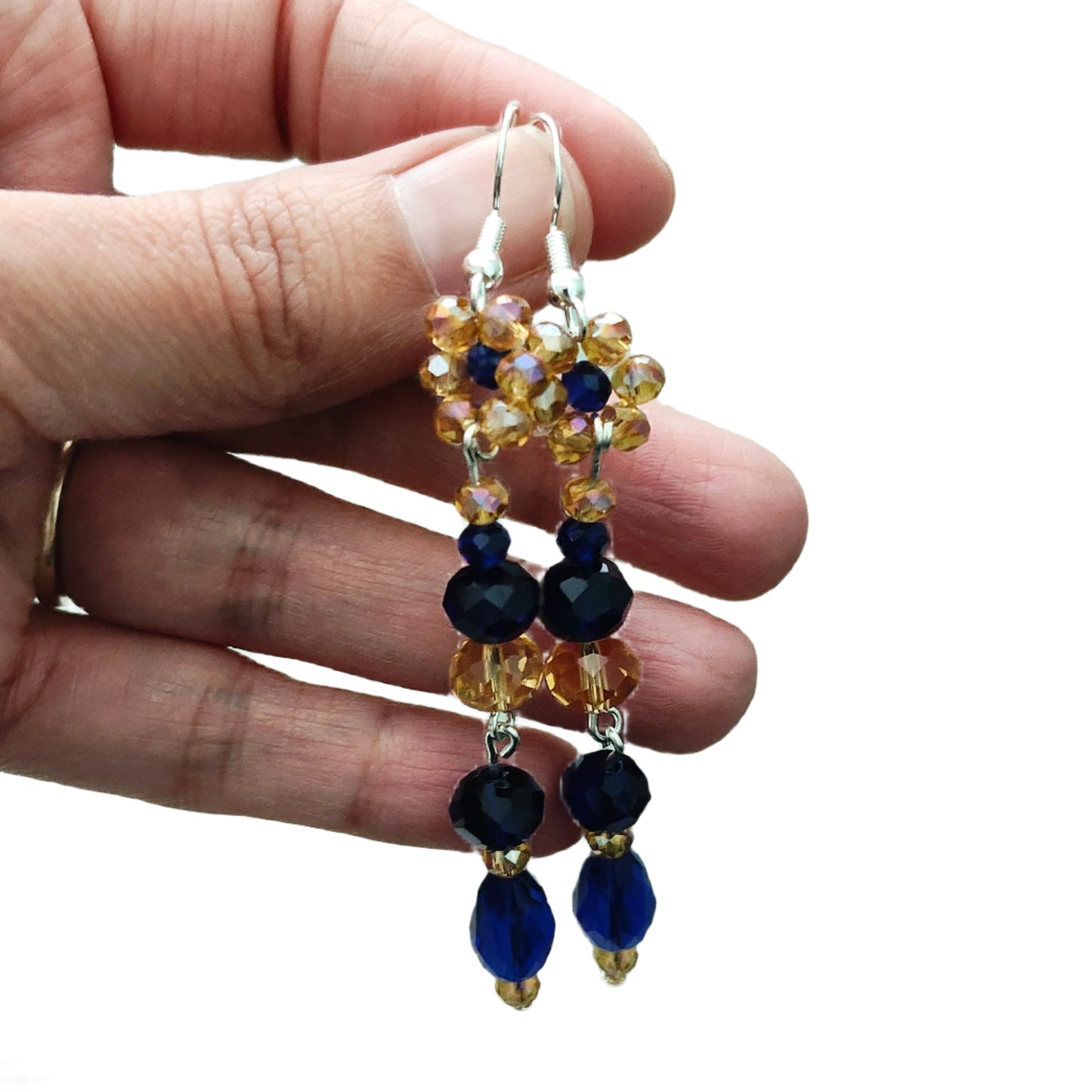 Add a touch of elegance to your outfit with these stunning earrings! The flower gold and navy long bead earrings on silver hook feature crystal beads that will catch the light and sparkle. With a length of approximately 3 inches and weighing only 0.23 oz, they are lightweight and comfortable for all-day wear. Elevate your style with these beautiful earrings now!