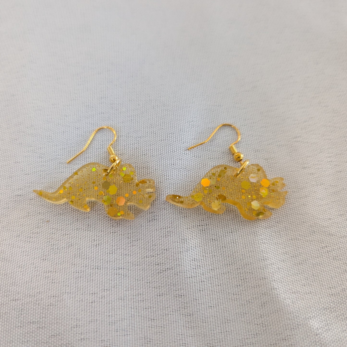 Unleash your wild side with these unique dinosaur earrings! Made of high-quality resin, these earrings are lightweight and comfortable to wear all day long. The perfect accessory for any dinosaur lover, these earrings are sure to add a fierce touch to any outfit. Get yours today and make a statement!