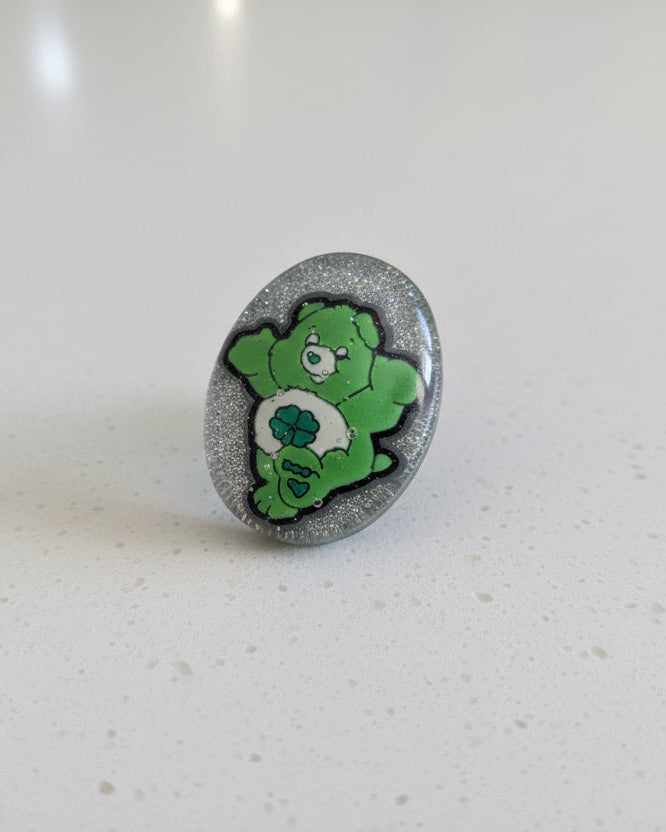 This 3D Care Bears resin pin adds a playful and nostalgic touch to any outfit or accessory. Crafted with detailed resin and secured by a silver butterfly clutch, it ensures both style and durability. Perfect for collectors or fans looking to brighten their day with a charming, wearable keepsake.