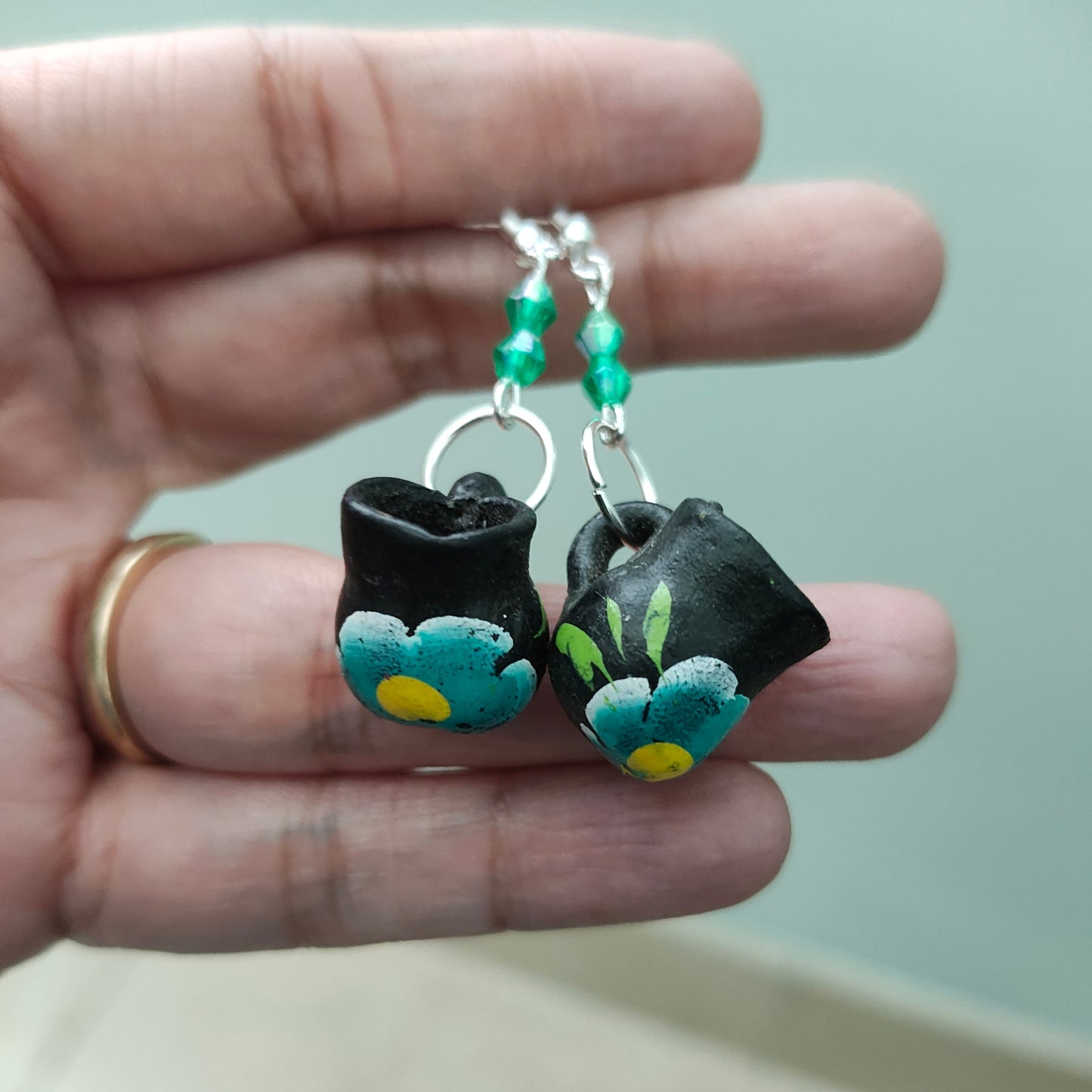 These quirky earrings feature a ceramic Mexican mug with colorful beads hanging from a silver hook. With a length of approximately 2 inches and a weight of only 0.14 oz, they are lightweight and comfortable to wear. Perfect for adding a unique touch to any outfit!