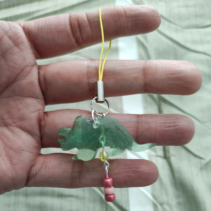 Add some prehistoric charm to your phone with our Triceratops resin dinosaur charm, adorned with colorful beads. Stand out from the herd and protect your phone in style. (No need to be a fossil to appreciate this cute accessory!)