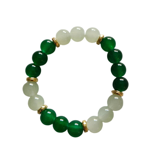 Elevate your style with our stunning elastic bracelet, featuring green and white 8mm glass beads and luxurious gold metal spacer beads. Effortlessly add a touch of elegance to any outfit while enjoying the comfort and convenience of an elastic band. Perfect for any occasion, this bracelet is a must-have for any fashion-forward individual!