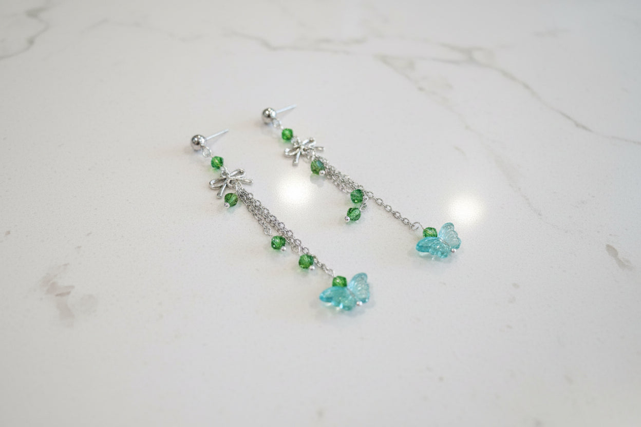 Elevate your everyday style with these enchanting butterfly earrings, featuring delicate silver chains, a charming bow accent, and sparkling crystal beads suspended from classic silver ball post studs. At approximately 3 inches in length, they offer the perfect balance of presence and wearability, making them ideal for both casual outings and special occasions. Weighing just 0.18 oz, these lightweight beauties won't weigh you down, allowing you to wear them comfortably all day long. The intricate design com