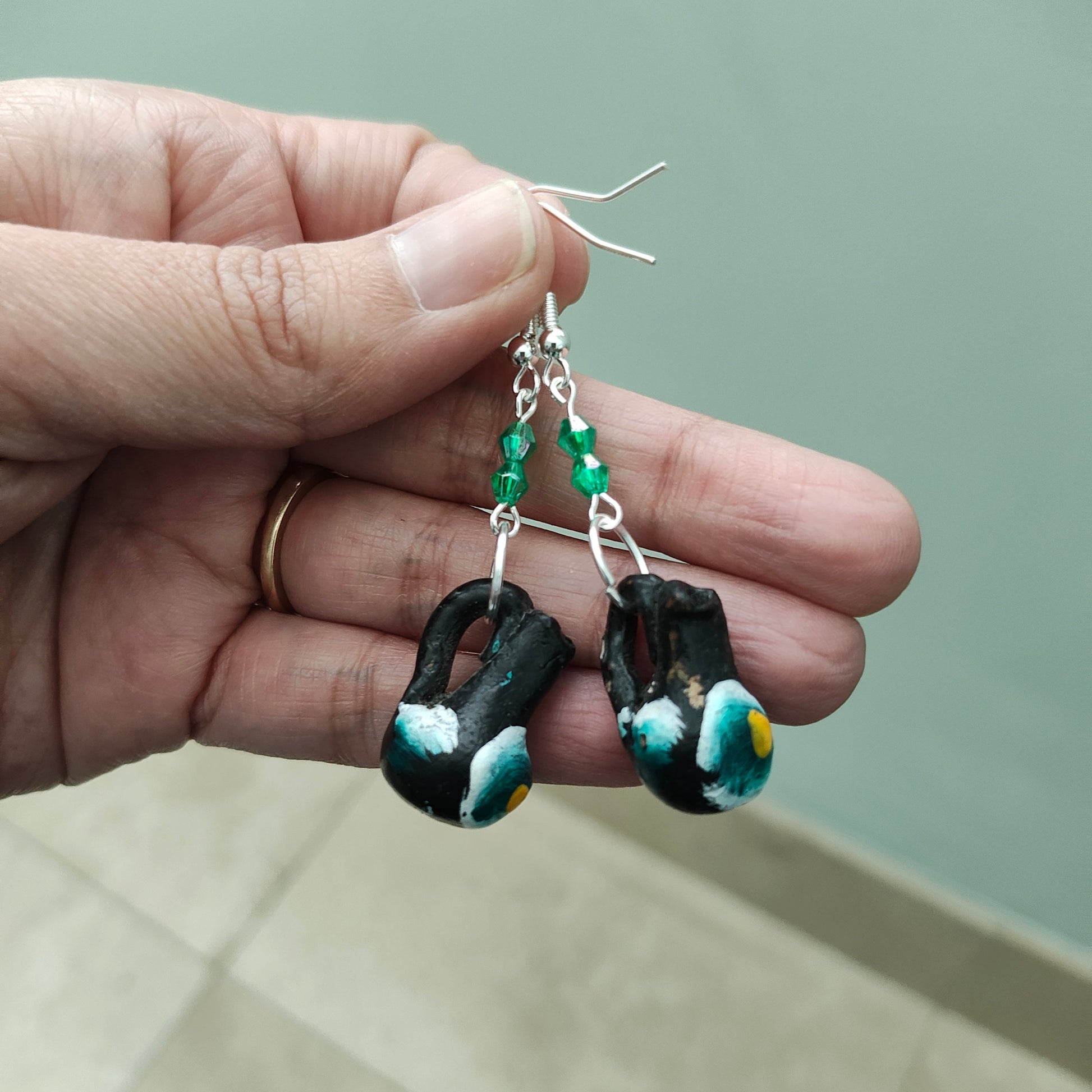 These quirky earrings feature a ceramic Mexican mug with colorful beads hanging from a silver hook. With a length of approximately 2 inches and a weight of only 0.14 oz, they are lightweight and comfortable to wear. Perfect for adding a unique touch to any outfit!
