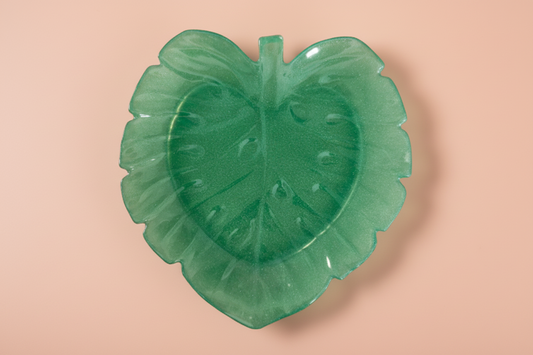 A green resin palm leaf-shaped trinket dish.