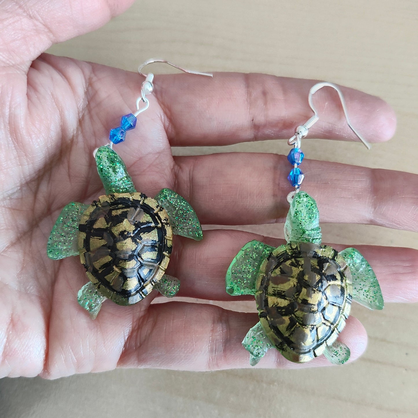 Add a touch of whimsy to your everyday look with our Earrings - Resin turtle on hook. These lightweight earrings feature a charming resin turtle design and a comfortable hook closure, perfect for any occasion. With a length of 2.5 inches and weighing only 0.36 ounces, they're both playful and practical. 