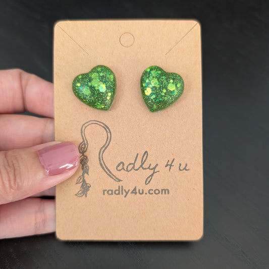Green glitter heart-shaped earrings on a  stainless steel stud.