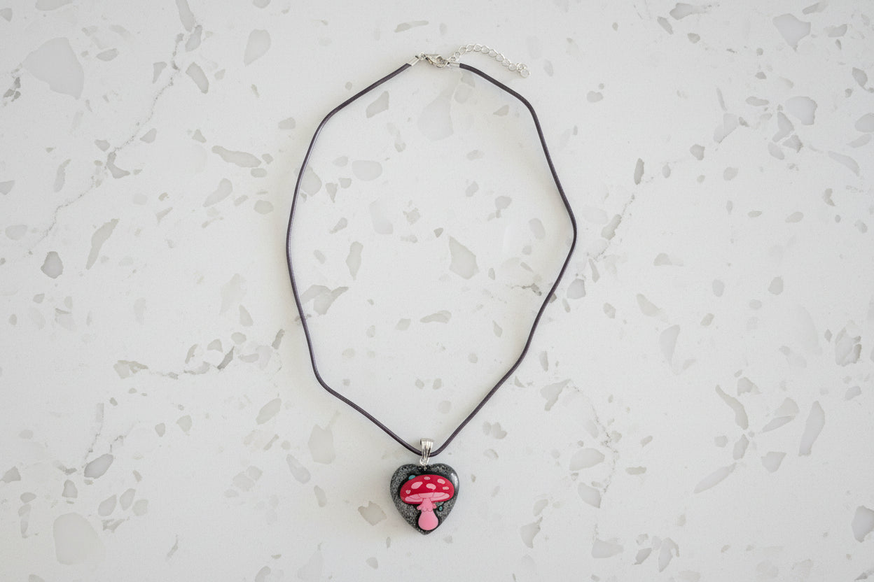 Necklace with a heart-shaped pendant on a light gray surface