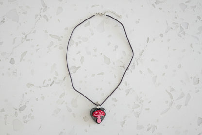 Necklace with a heart-shaped pendant on a light gray surface