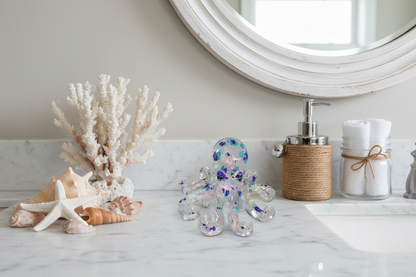 Perk up your decor with this Resin Small Octopus! This whimsical creature is just waiting to liven up your shelves, tables, or windowsills. With eight arms and a charming face, it's sure to be a conversation starter with its unique blend of cute and quirky! Get yours today and add some "squishy" fun to your home!