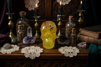 A yellow resin skull with floral patterns on the top and front