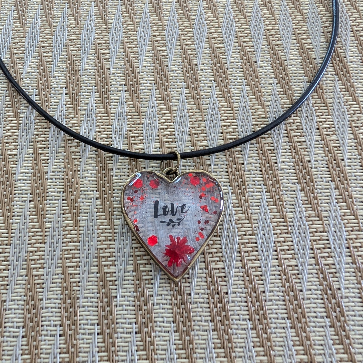This stunning necklace features an 18 inch black leather cord with a resin and flowers bronze heart pendant. The extension chain allows for a customizable fit. Weighing only 0.2 oz, it's a lightweight and stylish addition to any outfit. Show your love and creativity with this unique necklace.